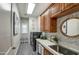 Charming laundry room with patterned wallpaper, wood cabinets, and modern washer and dryer at 22406 S 173Rd Way, Gilbert, AZ 85298