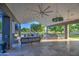 Expansive covered patio with sleek furniture and ceiling fans overlooking lush green lawn at 22406 S 173Rd Way, Gilbert, AZ 85298