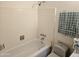 Bathtub with tiled walls, a shower head, faucet and toilet at 2423 E Flower St, Phoenix, AZ 85016