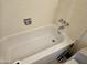 Bathroom features a bathtub with tiled walls, a shower head, and a toilet at 2423 E Flower St, Phoenix, AZ 85016