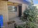 Welcoming front entrance with brick facade, complemented by a well-manicured garden and secure front door at 2423 E Flower St, Phoenix, AZ 85016