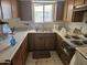 Functional kitchen with durable countertops and standard appliances, awaiting modern transformation at 2423 E Flower St, Phoenix, AZ 85016