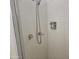 Tiled shower with shower head, fixtures and a shower door at 2423 E Flower St, Phoenix, AZ 85016