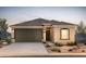 Charming single-story home with a tile roof, two-car garage, and desert landscaping at 25136 W Romley Rd, Buckeye, AZ 85326