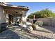 Inviting covered patio with ceiling fan, dining table and chairs, and mature landscaping at 25821 S Hollygreen Dr, Sun Lakes, AZ 85248