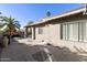 This backyard features desert landscaping and a covered patio space perfect for outdoor seating at 25821 S Hollygreen Dr, Sun Lakes, AZ 85248