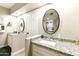 Well-lit bathroom featuring dual sinks with granite countertops, modern fixtures, and neutral decor at 25821 S Hollygreen Dr, Sun Lakes, AZ 85248