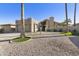 Charming beige single-story home with a two-car garage, desert landscaping, and bright blue skies at 25821 S Hollygreen Dr, Sun Lakes, AZ 85248