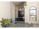 Elegant front door with tiled entryway, stylish potted plants, a bench, and decorative features at 25821 S Hollygreen Dr, Sun Lakes, AZ 85248