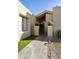 Beautiful front entrance with tiled path, desert landscaping, wrought iron gate and decorative planters at 25821 S Hollygreen Dr, Sun Lakes, AZ 85248