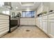 Bright kitchen with white cabinetry, stainless steel appliances, and granite countertops, showing spacious layout at 25821 S Hollygreen Dr, Sun Lakes, AZ 85248