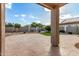 Covered patio in the private backyard with landscaping and desert scape at 25845 W Lynne Ln, Buckeye, AZ 85326