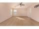 A bright bedroom featuring neutral carpet, a ceiling fan, and a TV mount on the wall at 25845 W Lynne Ln, Buckeye, AZ 85326