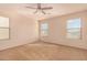 Bedroom showcasing multiple windows for natural light and neutral carpet at 25845 W Lynne Ln, Buckeye, AZ 85326