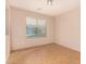 Neutral bedroom featuring tile floors, a window with blinds, and ample natural light for a serene living space at 25845 W Lynne Ln, Buckeye, AZ 85326