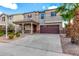 Exterior shot of a two-story home with a welcoming front porch and an attached two-car garage at 25845 W Lynne Ln, Buckeye, AZ 85326