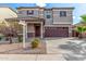 Beautiful front exterior featuring desert landscaping and a two-car garage at 25845 W Lynne Ln, Buckeye, AZ 85326