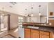 Well-lit kitchen featuring tile floors, a stylish faucet, and a breakfast bar, connecting to the adjacent dining area at 25845 W Lynne Ln, Buckeye, AZ 85326