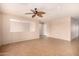 Spacious living room featuring tiled floors, neutral paint, and a clear view into another room for easy communication at 25845 W Lynne Ln, Buckeye, AZ 85326