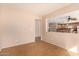 Comfortable living room with tiled flooring, neutral colors, and a peek into the kitchen, promoting easy interaction at 25845 W Lynne Ln, Buckeye, AZ 85326