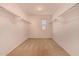 A walk-in closet featuring carpet, a window, and shelving on both sides at 25845 W Lynne Ln, Buckeye, AZ 85326