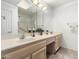 Bright bathroom with double vanity, shower and bath, and white cabinets at 26632 S Branchwood Ct, Sun Lakes, AZ 85248