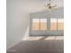 Bright living room with neutral carpet and two windows at 26632 S Branchwood Ct, Sun Lakes, AZ 85248