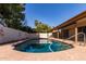 An inviting swimming pool with clear, blue water surrounded by lush landscaping at 26632 S Branchwood Ct, Sun Lakes, AZ 85248