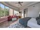 Bright bedroom featuring a cozy sitting area and balcony access with a view of the outdoor landscape at 28503 N 104Th Way, Scottsdale, AZ 85262