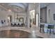 Open-concept dining room with a large table, elegant chandelier, and wet bar access at 28503 N 104Th Way, Scottsdale, AZ 85262