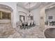 Elegant dining room featuring a large table set and stylish chandelier, with a view into additional living spaces at 28503 N 104Th Way, Scottsdale, AZ 85262