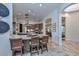 Open concept kitchen showcasing a large island with bar seating, stainless steel appliances, and seamless transition to living areas at 28503 N 104Th Way, Scottsdale, AZ 85262