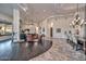 Spacious living room showcasing a seamless blend of hardwood and stone flooring and a luxurious seating area with a fireplace at 28503 N 104Th Way, Scottsdale, AZ 85262