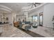 Bright living room featuring elegant curved ceilings, a comfortable grey sectional, and seamless transition to an outdoor view at 28503 N 104Th Way, Scottsdale, AZ 85262