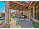 Covered patio featuring an outdoor kitchen and comfortable seating, perfect for outdoor gatherings and dining at 28503 N 104Th Way, Scottsdale, AZ 85262