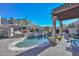 A backyard swimming pool with a relaxing spa and a decorative pergola, creating a tranquil outdoor oasis at 28503 N 104Th Way, Scottsdale, AZ 85262