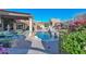 Resort-style pool area with lush landscaping, multiple seating areas, and a serene water feature at 28503 N 104Th Way, Scottsdale, AZ 85262