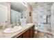 Bathroom featuring double sinks, decorative wall, framed mirror and bathtub with light blue shower curtain at 2868 E Dunbar Dr, Phoenix, AZ 85042