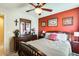 Bedroom with wood furniture, ceiling fan and decorative wall art at 2868 E Dunbar Dr, Phoenix, AZ 85042