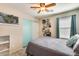 This bedroom includes a ceiling fan and a sports theme with art at 2868 E Dunbar Dr, Phoenix, AZ 85042