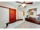 Bedroom with wood furniture, ceiling fan and red closet door at 2868 E Dunbar Dr, Phoenix, AZ 85042