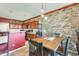 The dining area features decorative stone wall accents, pendant lights, and a view to the adjacent kitchen at 2868 E Dunbar Dr, Phoenix, AZ 85042