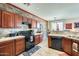 Charming kitchen features stone accent wall, wood cabinetry, tile floors, and modern appliances at 2868 E Dunbar Dr, Phoenix, AZ 85042