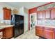 The kitchen shows wood cabinets, a black refrigerator, and access to the laundry room at 2868 E Dunbar Dr, Phoenix, AZ 85042