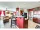 This kitchen has a breakfast bar, with views to the living room and a laundry room at 2868 E Dunbar Dr, Phoenix, AZ 85042