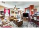 Cozy living room with wood tile floors, a ceiling fan, comfortable furnishings and a view to breakfast bar at 2868 E Dunbar Dr, Phoenix, AZ 85042