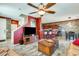 Open living room with wood tile floors, a ceiling fan, and view to the kitchen and breakfast bar at 2868 E Dunbar Dr, Phoenix, AZ 85042