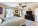 Comfortable main bedroom features a ceiling fan, accent curtains, and natural light at 2868 E Dunbar Dr, Phoenix, AZ 85042