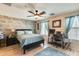 Spacious main bedroom with a wood accent wall, ceiling fan, and wood-style flooring at 2868 E Dunbar Dr, Phoenix, AZ 85042