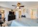 Bright and airy main bedroom featuring ceiling fan and view to ensuite bathroom and walk-in closet at 2868 E Dunbar Dr, Phoenix, AZ 85042